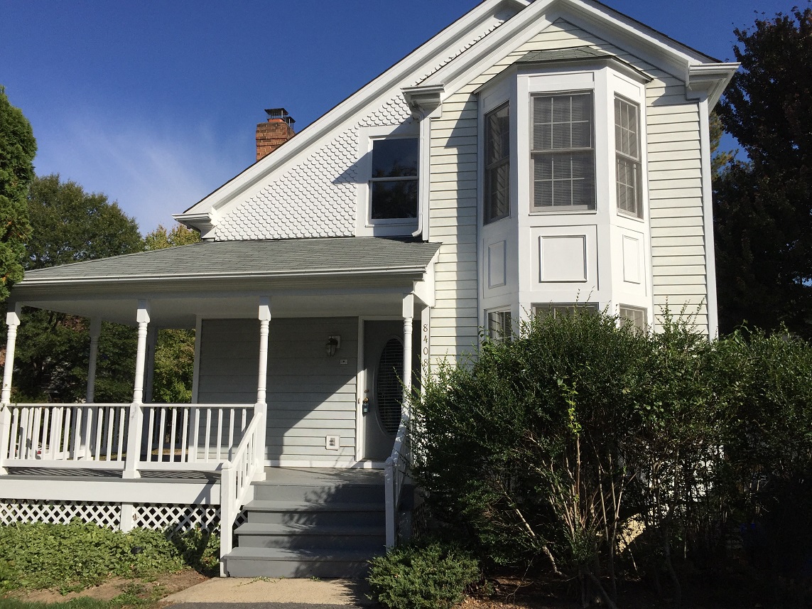 a white house with a porch and white stairs